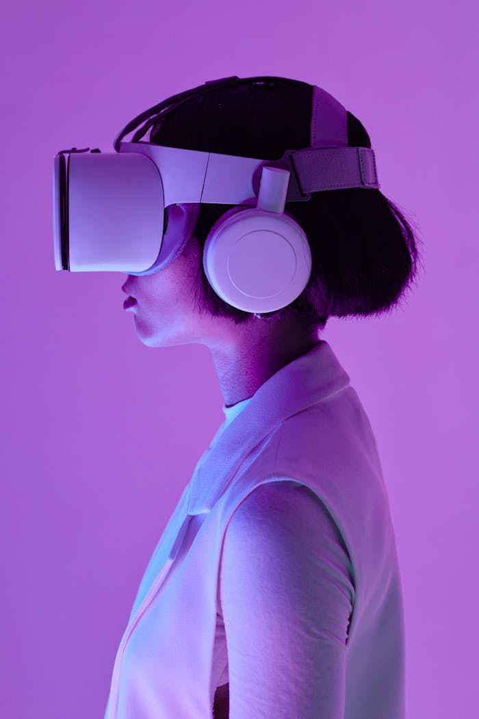 our-story Side profile of a woman wearing VR goggles in a studio with purple lighting, embodying future tech.